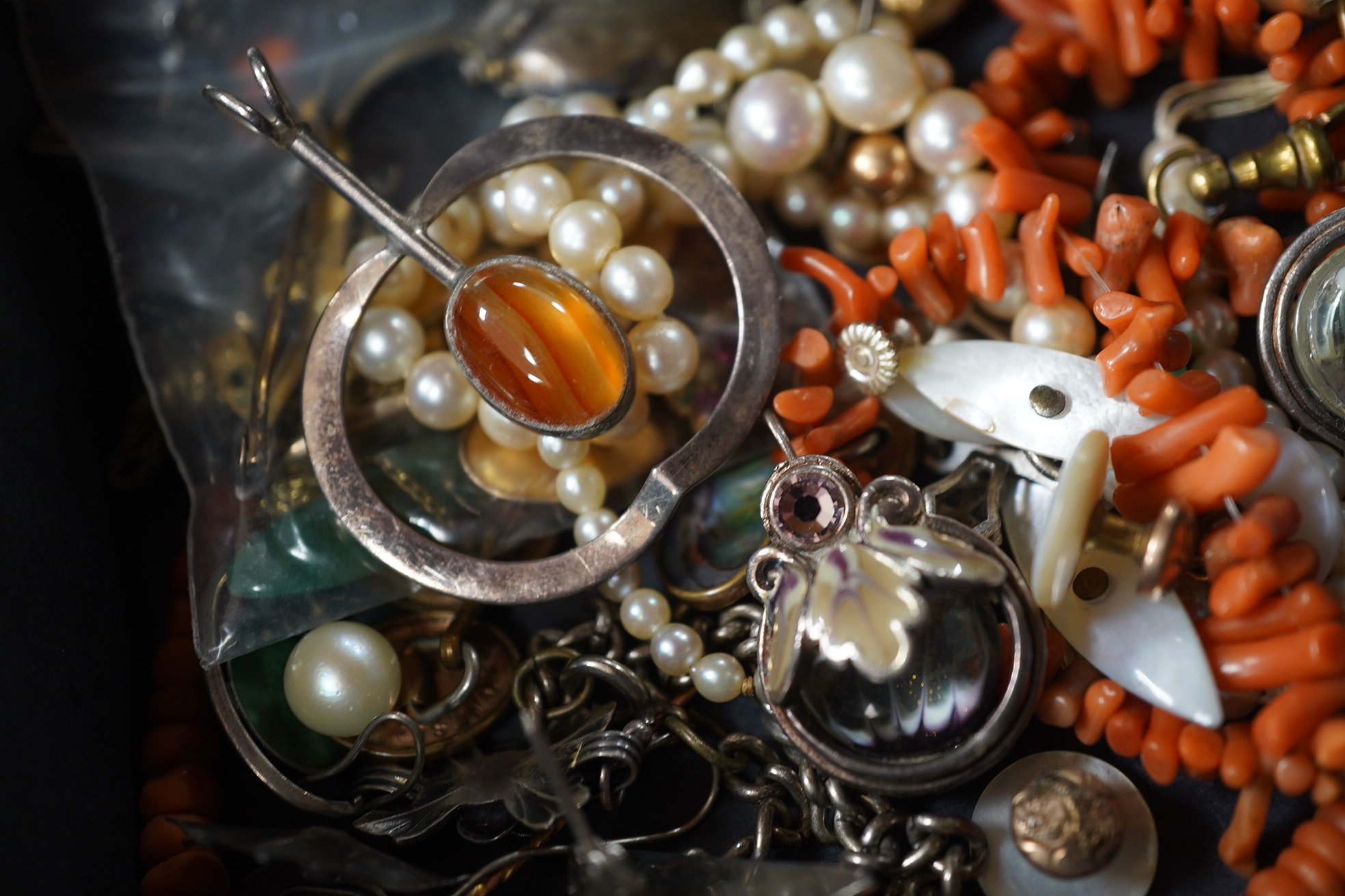 A quantity of assorted mainly costume jewellery including tortoiseshell and pique pendant, coral necklace, cultured pearl necklace, etc. Condition - poor to fair